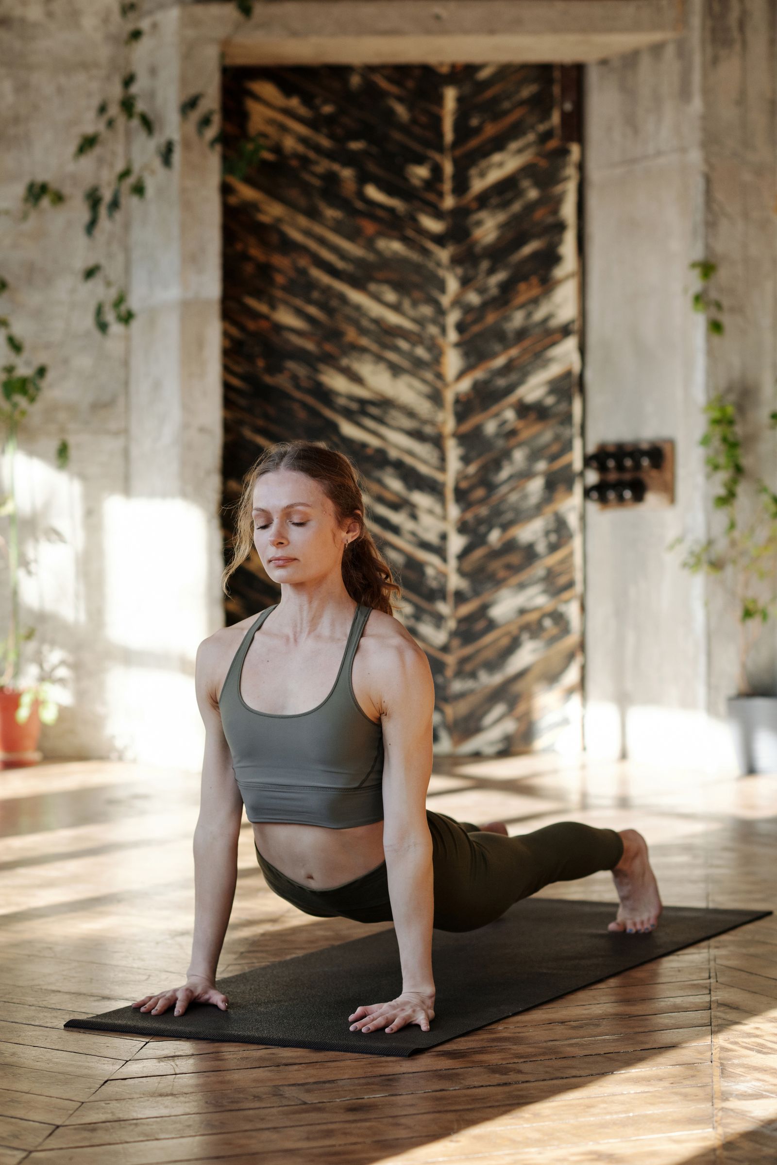 A person stretching calmly in soft natural light.
